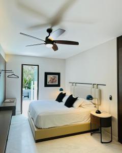 墨西哥城马纳克度假屋的一间卧室配有一张床和吊扇