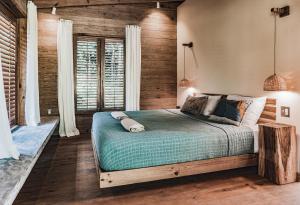 博卡斯德尔托罗Bocas Garden Lodges的一间卧室设有一张床和木墙