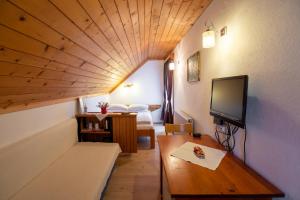 博希尼Sobe Odar Andrej的客房设有1张床、1台电视和1张桌子。