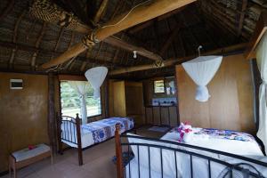 Wayasewa IslandWaya Lailai Eco Haven的一间带两张床的卧室和一个阳台