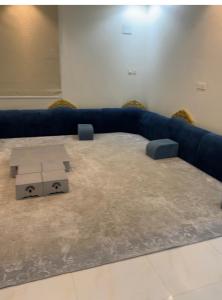 Sūq al Aḩadشقق فخمه的客厅配有蓝色的沙发和桌子