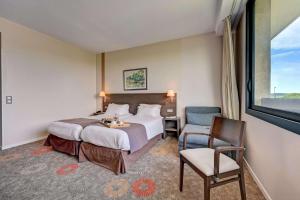佩尔蒂塞万公园贝斯特韦斯特酒店的卧室配有床、椅子和窗户。