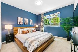 洛杉矶Beverly Grove Chic City Oasis 2 BR Apt with Den 138的蓝色的卧室设有床和窗户