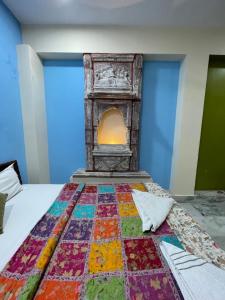 焦特布尔Swiss House的一张床上的五颜六色的被子,壁炉