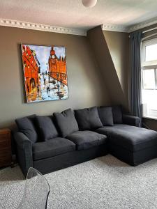 基尔Traumhafter Altbaucharme in zentraler Lage的客厅配有沙发和墙上的绘画