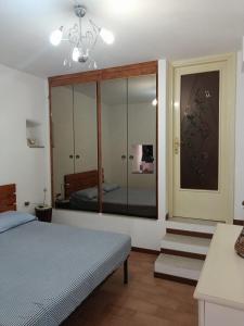 波焦莫亚诺Casa Mia的一间卧室配有一张床和一个大型玻璃衣柜