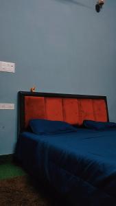 马图拉Manavi Home Stay的一张蓝色和红色床头板的床