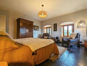 圣普里瓦达利耶克洛斯红石酒店的一间卧室配有一张大床和两把椅子
