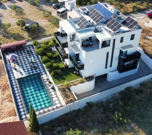罗戈兹尼察VILLA JANE INN的享有房子的空中景色,上面设有太阳能电池板