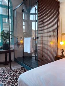 海法Talpiot Oasis-Louis的浴室设有玻璃淋浴间、一张床和一个水槽