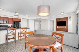 迈阿密海滩TRUMP INTL 2 BEDROOM APARTMENT 1600 Sqf OCEAN FRONT的厨房以及带桌椅的起居室。