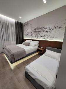 吉诺卡斯特Jani Studio Apartments的两张位于酒店客房的床,墙上有地图