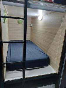 丹那拉打BRICKS Backpackers Sleepbox的拖车内的双层床,配有蓝色床垫