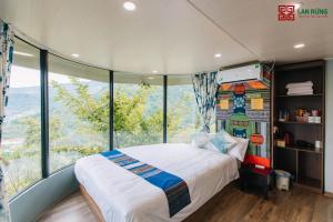 萨帕Lan Rung Brocade Hotel的一间卧室设有一张床和一个大窗户