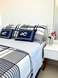 巴雷里尼亚斯Lençóis Confort 201的一间卧室配有一张带蓝色和白色枕头的床