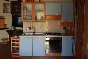 圣马西莫Cottage Ani & Mau的厨房配有白色橱柜和炉灶烤箱。