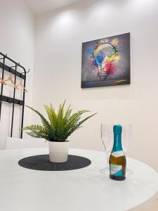 巴勒莫Valguarnera Studio Apartments的桌子上放有一瓶葡萄酒和两杯酒