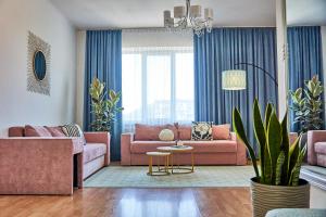 穆卡切沃Wonderful Panoramic View Apartment的客厅配有粉色家具和蓝色窗帘