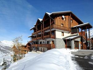 LevassaixAppartement Les Menuires, 3 pièces, 6 personnes - FR-1-344-849的一座白雪覆盖的山顶上的建筑