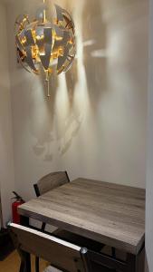 马尼拉Century Properties/ Aqua Iguazo Condo Unit的墙上挂着吊灯的餐桌
