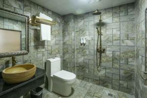 张家界Mountain View Guesthouse的浴室配有卫生间、盥洗盆和淋浴。