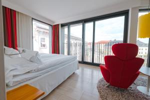 哥德堡阿瓦隆酒店的一间卧室设有红色椅子和大窗户