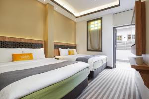 新加坡Dash Living Rochor的酒店客房设有两张床和窗户。