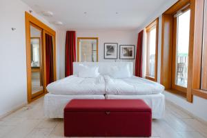 哥德堡阿瓦隆酒店的一间卧室设有两张床和一张红色的搁脚凳