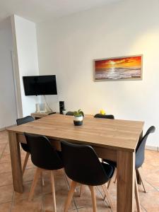 托里德欧索VILLA ENA的木制用餐室配有桌椅和电视