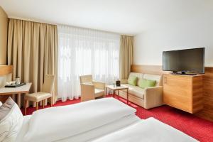 维也纳奥地利阿纳托尔维也纳时尚酒店的配有一张床和一台平面电视的酒店客房