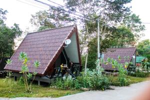 万象Soutchai Resort的两个人坐在房子外面的房子