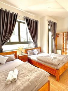 大叻Khoảng Lặng ATP的一间卧室设有两张床和窗户。