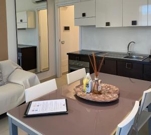 代森扎诺-德尔加达Residence Del Lago的一间带桌子的客厅和一间厨房
