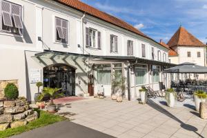 巴特拉德克斯堡奥地利帝王历史温泉酒店的一座白色的大建筑,前面设有一个庭院