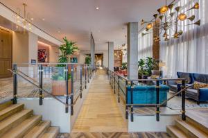 弗吉尼亚海滩Embassy Suites By Hilton Virginia Beach Oceanfront Resort的酒店大堂设有楼梯和椅子