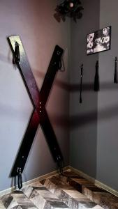 罗兹BDSM Red Room Apartment的房间的墙上有木十字架