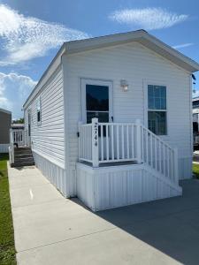 基西米Cozy Tiny Home Near Disney World & Orlando Parks!的白色的小房子设有门廊和阳台