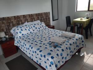 比亚米尔港My House的一间卧室配有一张带蓝色和白色棉被的床