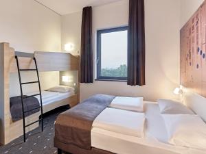 特罗斯多夫B&B Hotel Köln-Troisdorf的一间卧室配有一张双层床和梯子