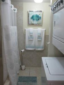 西湾Fabulous one bedroom in West Bay的带淋浴、卫生间和毛巾的浴室