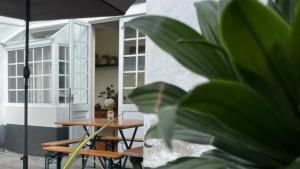 富尔纳斯A Vista dos Verdes的一个带桌子和遮阳伞的庭院