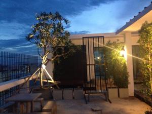 Kamphaeng Saen米图坎盘沙恩公寓式酒店的阳台配有桌子和树