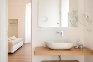 莫诺波利Casa Del Barone - Luxury Suites的白色的浴室设有水槽和镜子