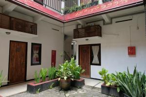 日惹Mawar Asri Hotel的两扇门,前面有植物