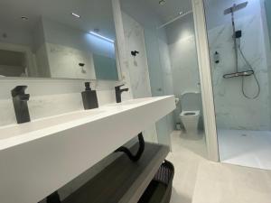 莱昂HOSTEL ALEA的白色的浴室设有水槽和卫生间。