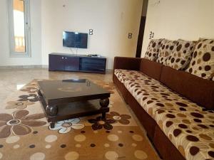 El-Qaṭṭaفيلا للايجار في كمبوند سمر قند的带沙发和咖啡桌的客厅