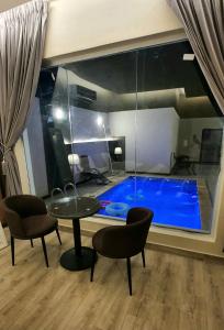 Al ‘Awājīyahشاليهات z5 الفندقية的客房设有带桌椅的游泳池。