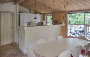 奥贝克Gorgeous Home In lbk With Sauna的厨房以及带白色桌椅的用餐室。