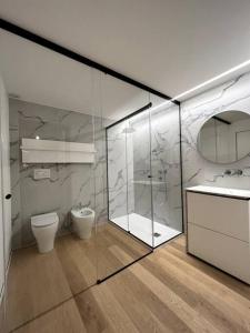 洛韦雷Dream Suite Lago D’iseo的一间带玻璃淋浴和卫生间的浴室