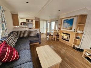 博斯Caravan 4 - Cambrian Coast Caravan Park的客厅配有沙发和桌子